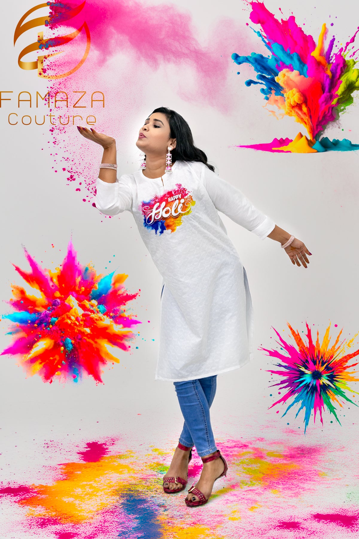 A woman wearing a white cotton kurti with Schiffli Chikankari embroidery, celebrating Holi with colourful powder in the air around her.