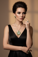 A woman in a black satin dress models a green and white gemstone pendant necklace, matching green earrings, and a green ring against a warm beige background.