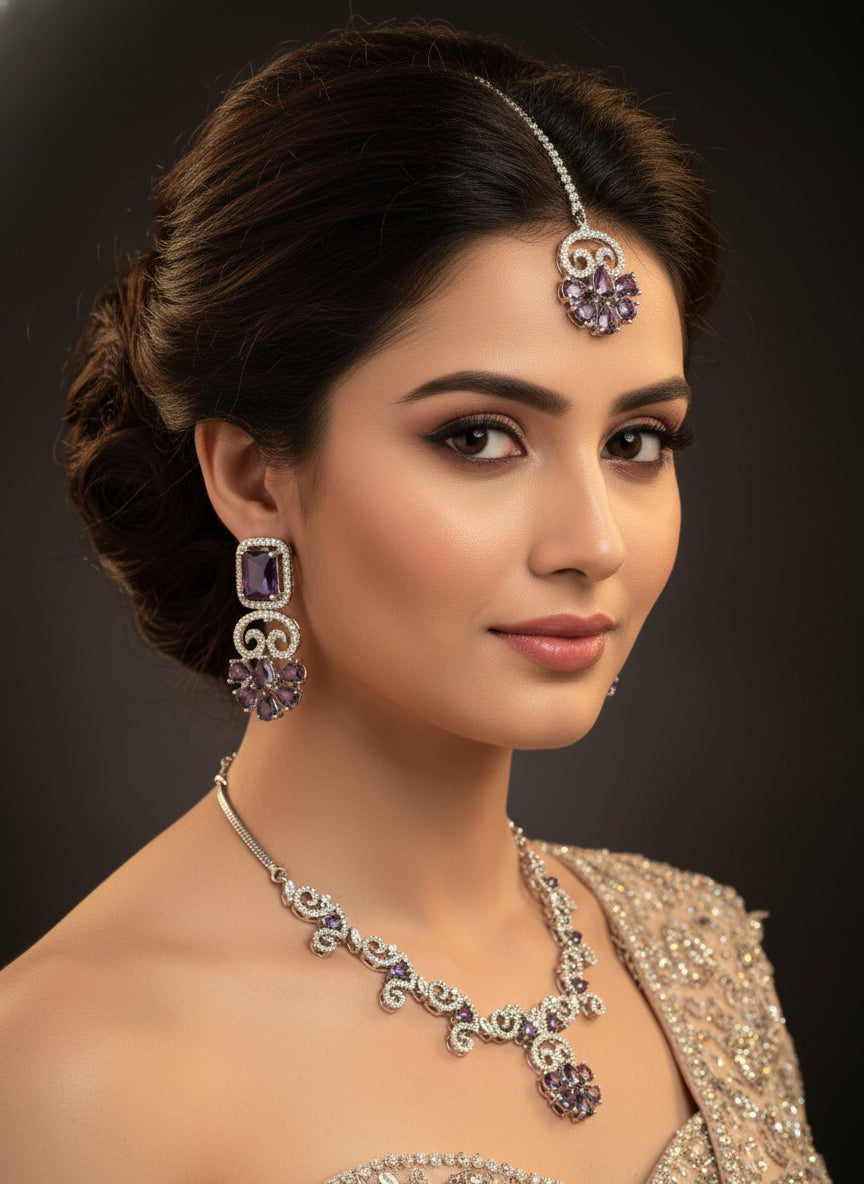 American diamond white stones with purple stone in the centre on this jewellery set includes necklace, earrings and maang tikka by famaza couture 