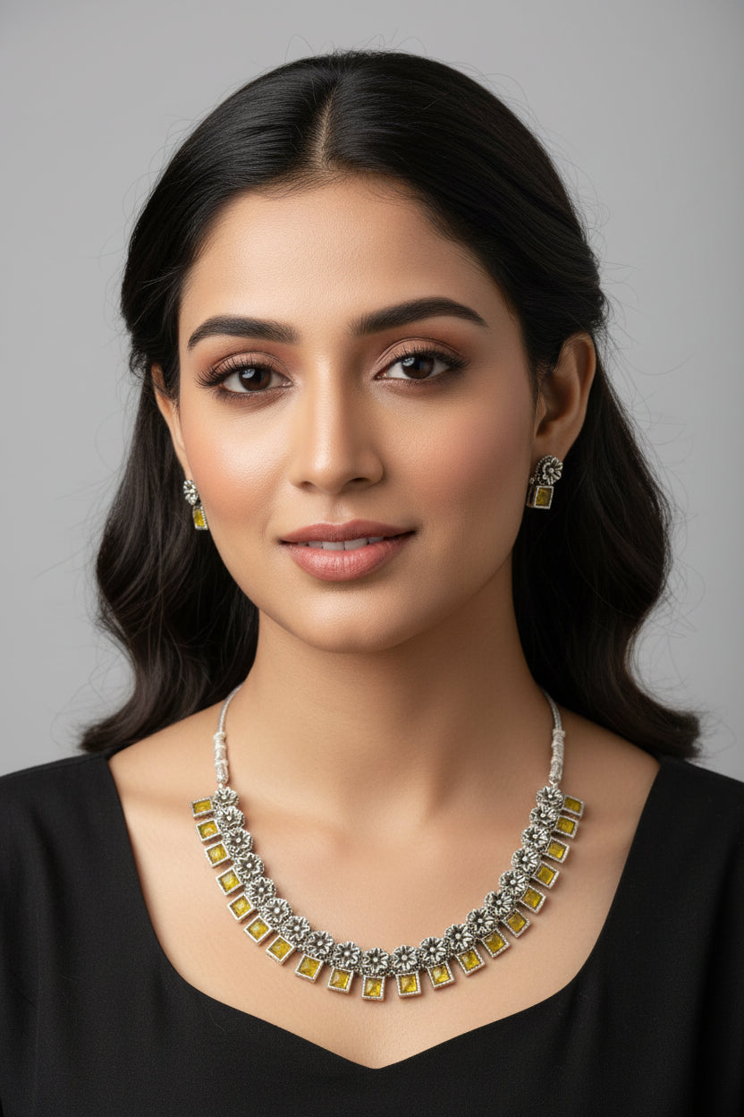  An oxidised silver necklace featuring floral links and square yellow stones.