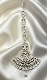Anfal silver fan-shaped AD maang tikka with clear cubic zirconia stones on cream silk — Famaza Couture premium silver bridal forehead jewelry.