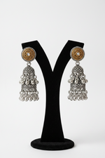 Close-up of stone studding and dual-tone gold and silver filigree detailing on jhumka