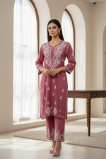Antique Pink base colour with white silk thread embroidered 2pcdress and matching trousers displayed on hangers.