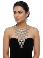 Oxidized silver tiered Y-shaped statement necklace set with mirror accents and matching jhumka dangle earrings — worn with black strapless outfit, South Asian bridal & party jewelry.