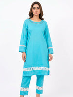 A model wearing a knee-length aqua blue plain cotton kurta with white cut-work lace detailing on the neckline, sleeves, and hem, paired with matching straight-leg trousers.