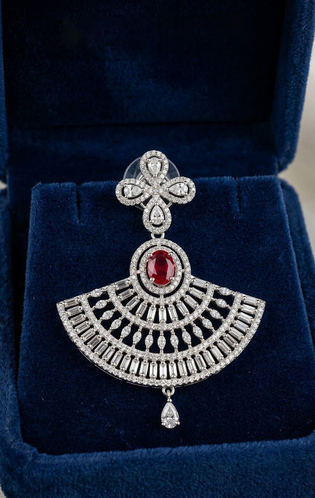 Aria luxury ruby red oval and clear zircon stone fan-shaped drop earring displayed inside a premium royal blue velvet gift box.