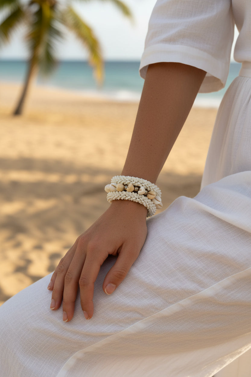 Beaded bracelet with shell accents on a textured surface
