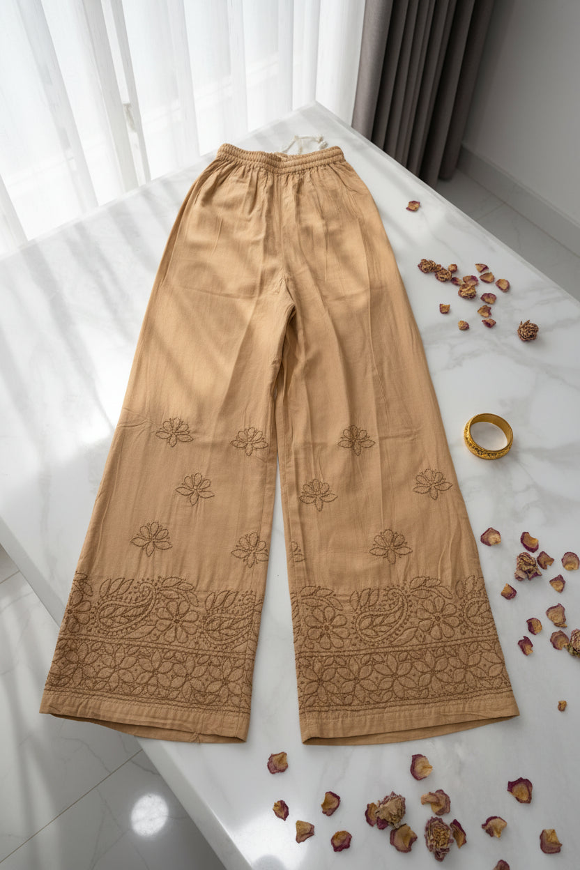 Beige embroidered fabric on a white marble surface