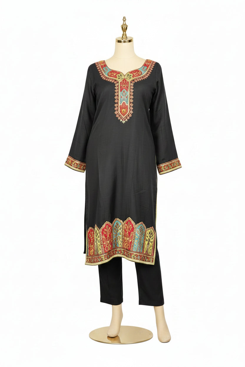 A black silk kurta set featuring Kanni embroidery and zari work, paired with a Banarasi chiffon dupatta and raw silk trousers, displayed on a high-end stand against a pure white background.