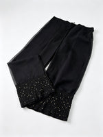 Black georgette pants with black thread hand embroidery and antique gold kaamdani work. 