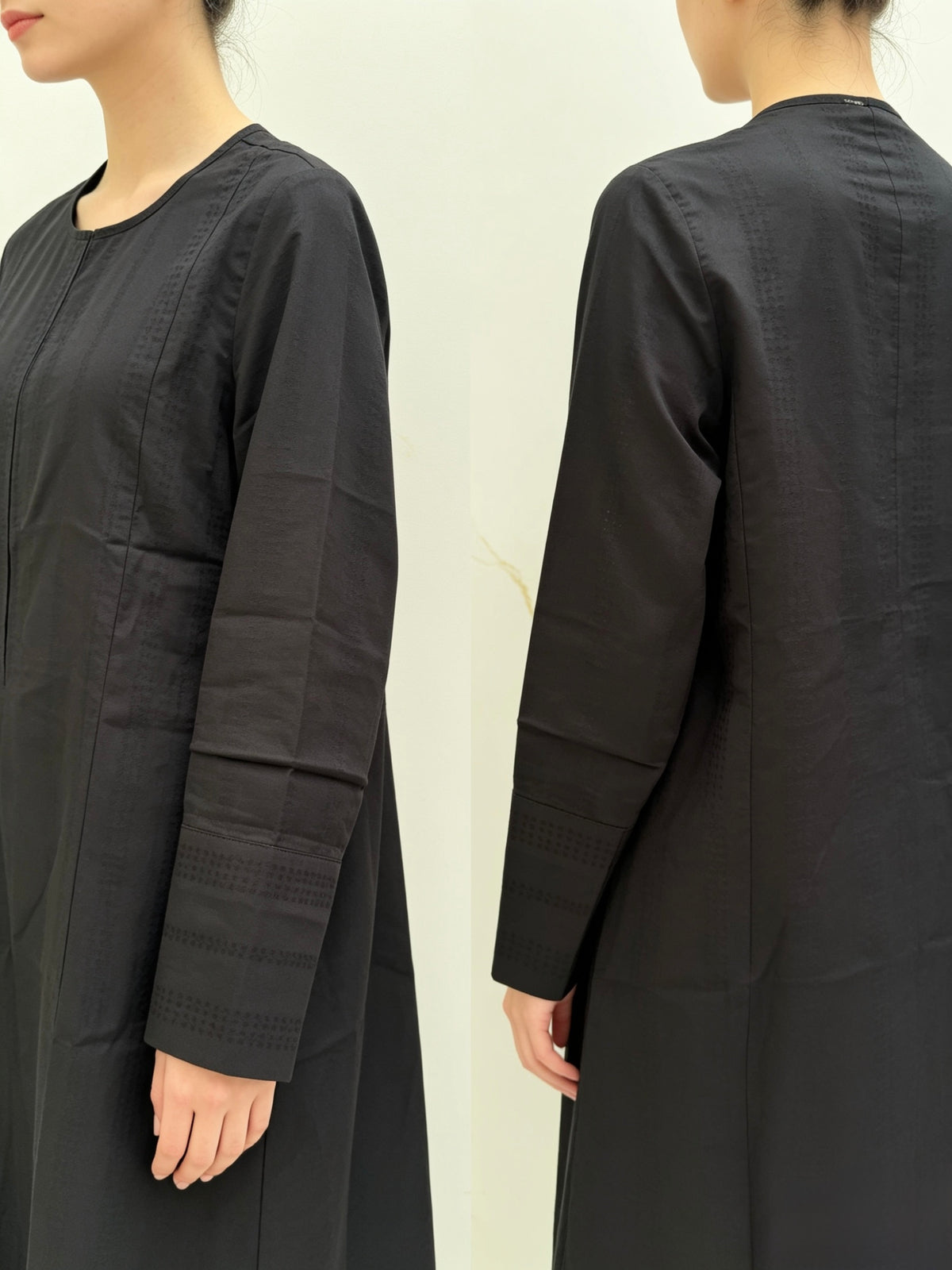 Black long-sleeve dress worn by a person on a plain background