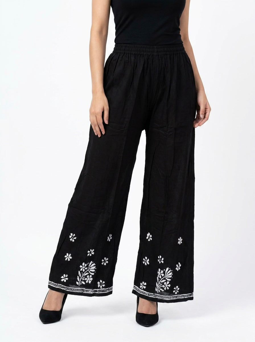 Black modal straight trousers with white silk Ghasspati embroidery front view