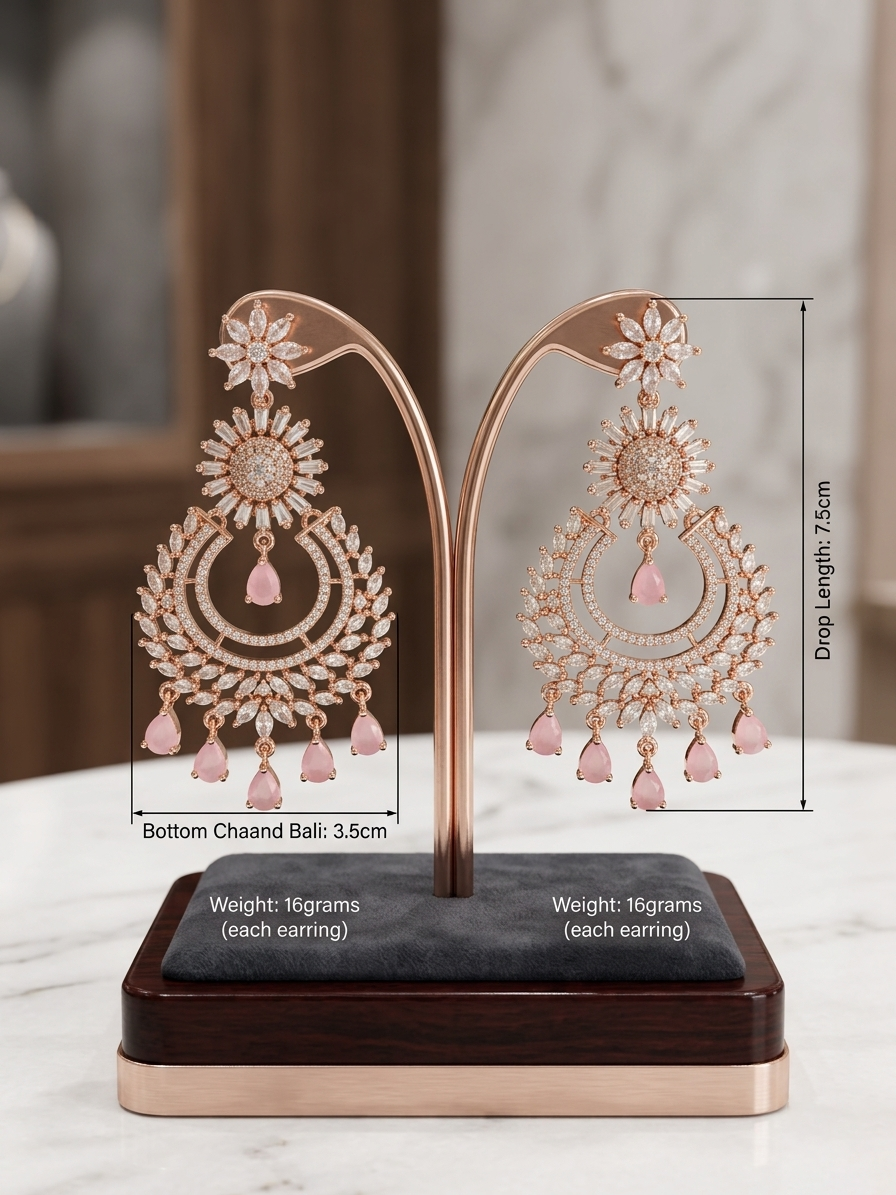 A pair of luxury rose gold chaand bali chandelier earrings on a jewelry display stand, featuring clear marquise American Diamonds in a floral sunburst design with hanging blush pink teardrop gemstones.