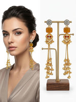  Bold statement earrings with a gold-textured wreath design and a vibrant orange stone pendant.