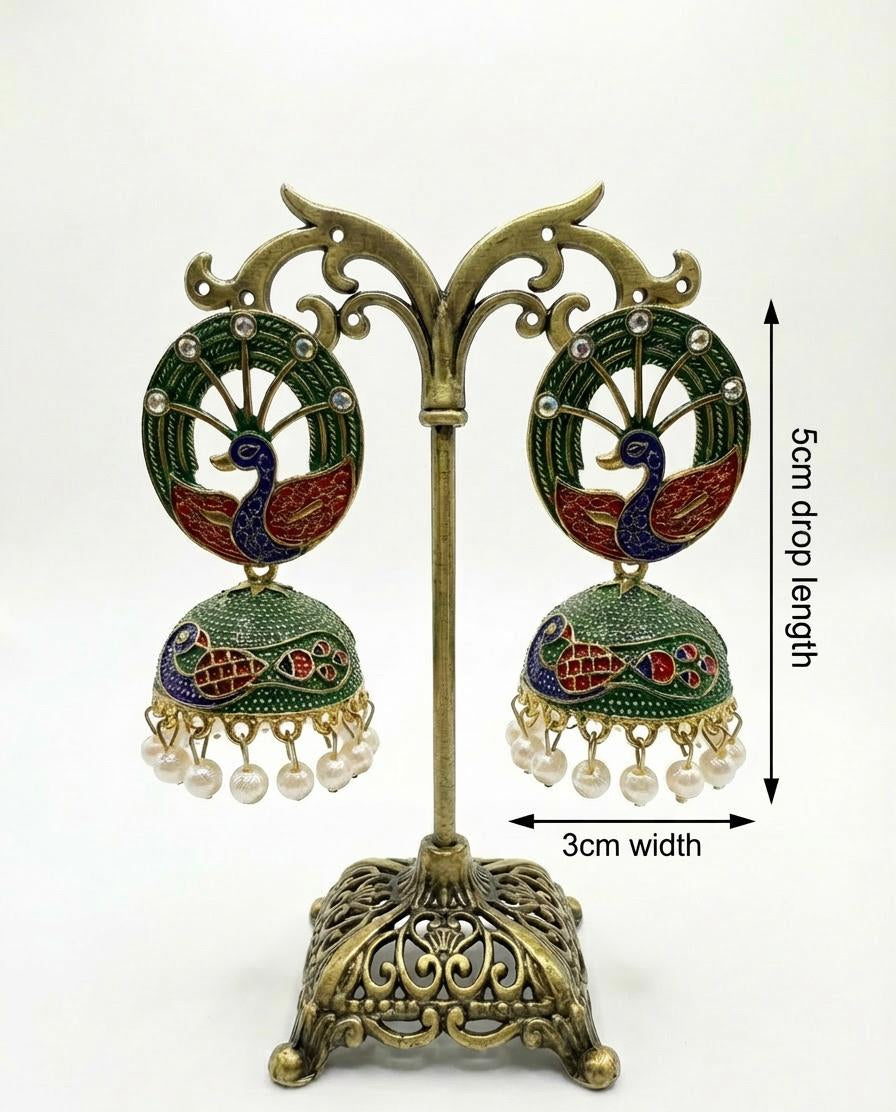 Bottle green Meenakari peacock earrings on a display stand showcasing the intricate hand-painted bird motif.