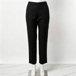 Mannequin display focusing on the matching black trousers of the co-ord set, featuring subtle embroidery detail at the hems against a white marble floor.