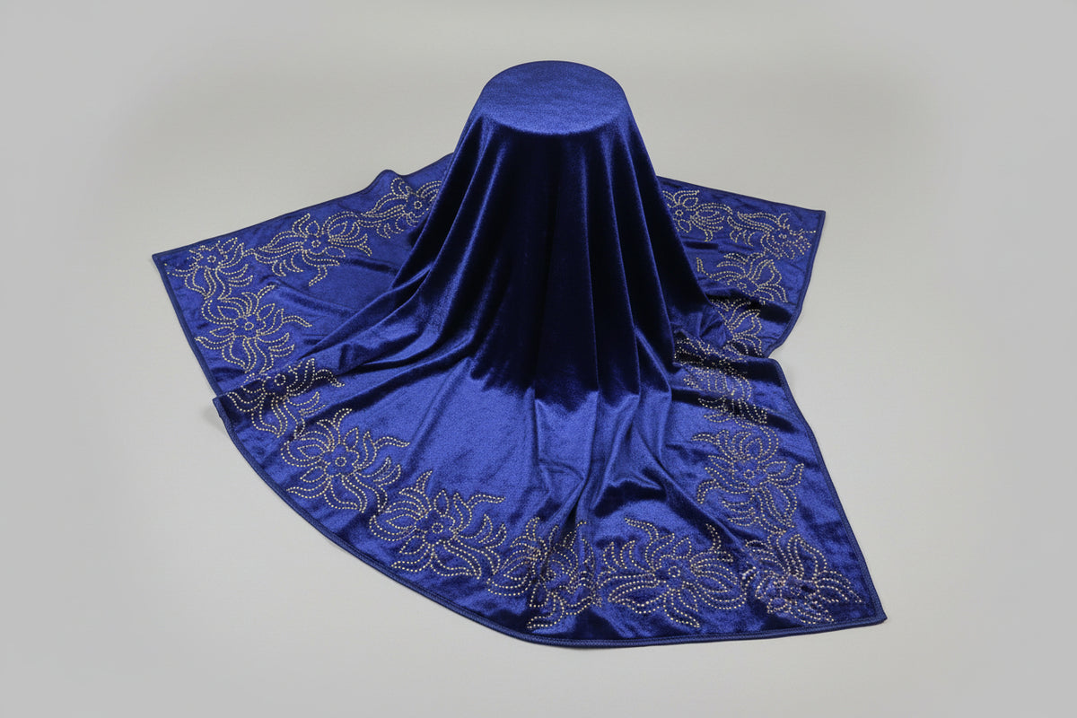 Close-up of a blue velvet stole with Swarovski embellishments and floral patterns.