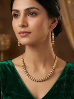  Close-up of a girl wearing the gold-plated brass nano multicoloured bead choker set with matching earrings.