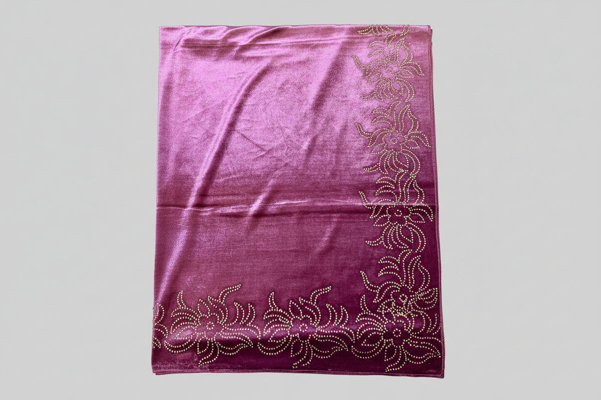 Close-up of a purple velvet stole with Swarovski embellishments and floral patterns.