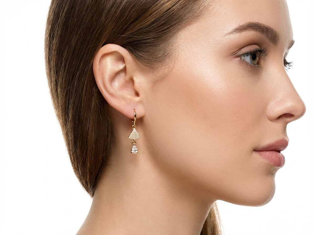 Close-up of a woman wearing a American diamond earring on a white background