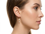 Close-up of a woman wearing a American diamond earring on a white background
