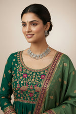 Close-up of a woman wearing a heavy oxidised choker featuring carved floral mandalas and matching tiered drop earrings.