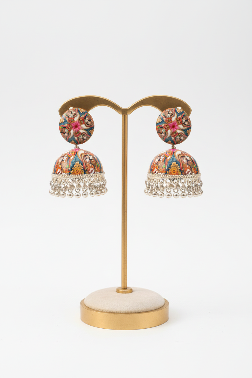 Pair of floral earrings on a gold earring stand with a white background