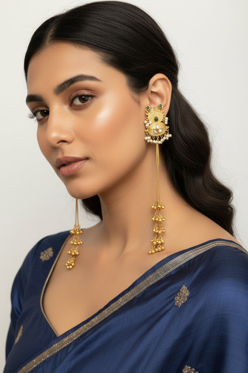 Close-up of model showcasing dramatic 22cm bottle green gold bell earrings, perfect for party wear and bridal jewellery.