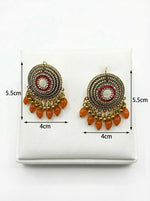  Close-up of the brass filigree pattern, central Korean stones, and the vibrant orange beads hanging from the base.