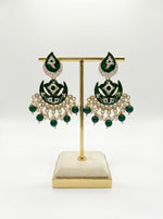  Close-up of the deep green polished stones and the ornate floral silver-tone centerpiece with a small pearl-style accent.