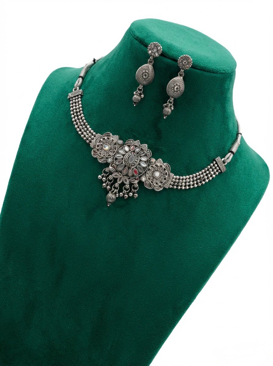  Close-up of the handcrafted oxidised silver finish featuring intricate petal designs and small metallic droplets.