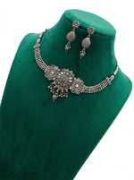  Close-up of the handcrafted oxidised silver finish featuring intricate petal designs and small metallic droplets.
