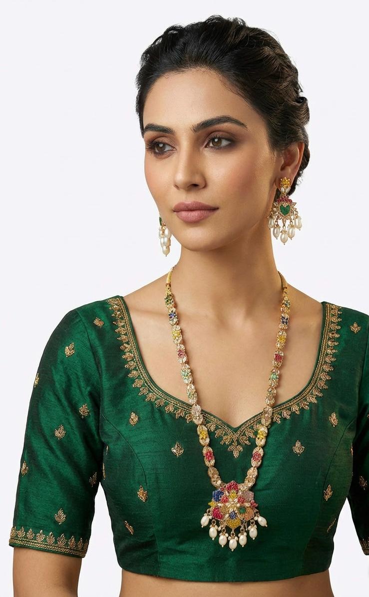 Close-up of the long necklace and earrings showing the intricate multi-color floral pendant and matching chain motifs on a model.