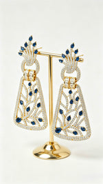 Close-up shot of Royal Sapphire Filigree statement drop earrings with brilliant blue stones.