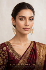 A woman wearing ornate gold hoop earrings with dangling chains, paired with a deep maroon and gold embroidered traditional garment. The brand name 'FORMASA COUTURE' is displayed at the bottom of the image.