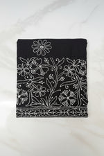Close up white Chikankari paisley hand embroidery on black cotton flared pants