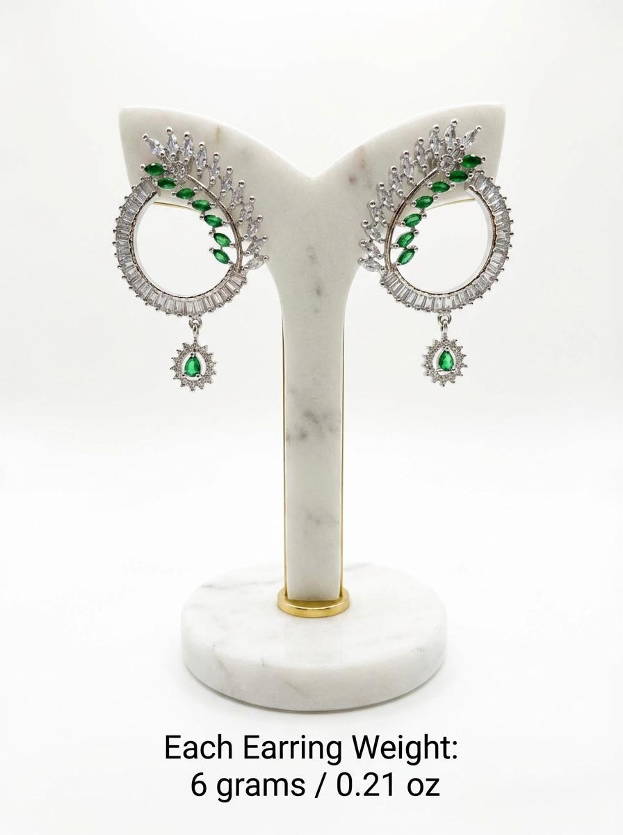 Contemporary green and white crystal statement earrings with a unique open-circle design and polished silver finish.