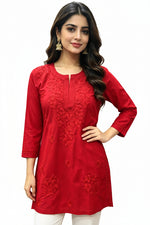 Model wearing a vibrant red short kurti detailed with intricate floral embroidery, presented as a standalone short kurti without bottom trousers.