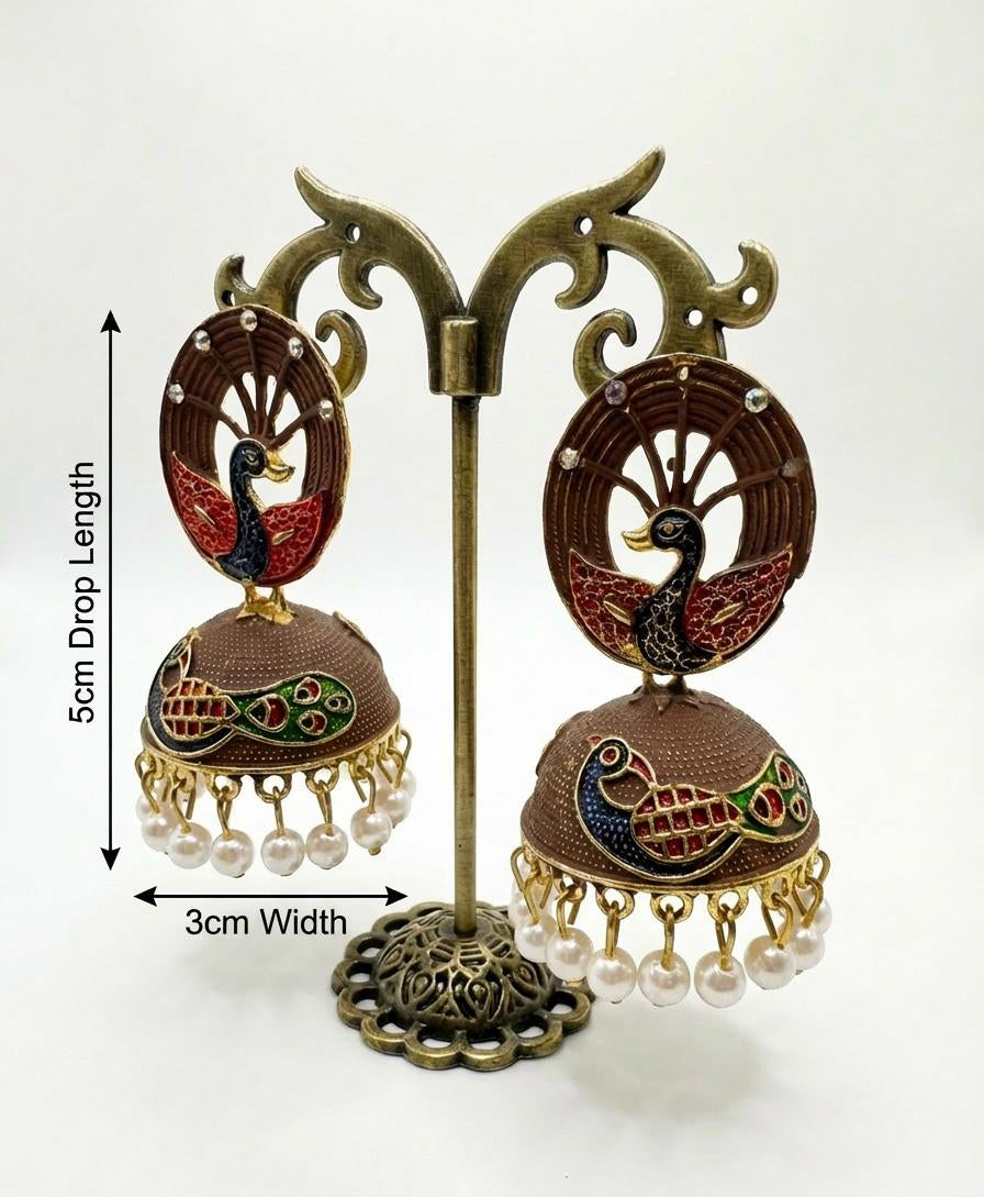 Dark chocolate brown 5.5cm peacock jhumkas with white pearl drops on a professional jewelry display.