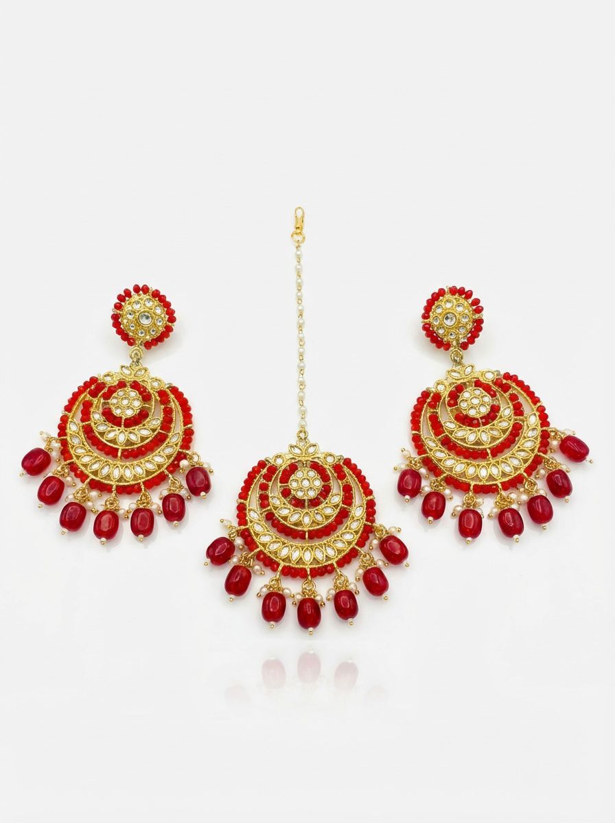 Detailed close-up of circular rose gold ethnic earrings featuring a kundan center and a ruby-toned fringe.