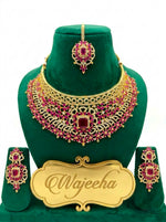 Detailed flat lay view of imperial bridal necklace , matching chandelier earrings and tikka.