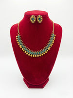  Detailed product shot of the green stone necklace and stud earrings set displayed on a premium white jewellery stand.