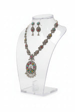 Detailed shot of the multicolor stone inlays, and silver-tone bead drops on the necklace pendant.