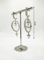 Detailed studio view of silver hoop earrings on a display stand, highlighting the 3cm width and shimmering stone-encrusted design.