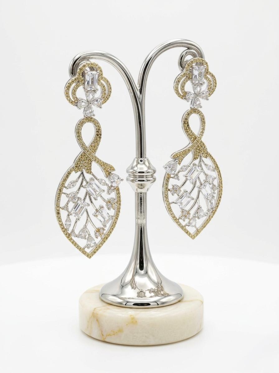 Detailed studio view of the Gold American Diamond leaf-motif dangles, highlighting the 2cm width and shimmering stone-encrusted frame.