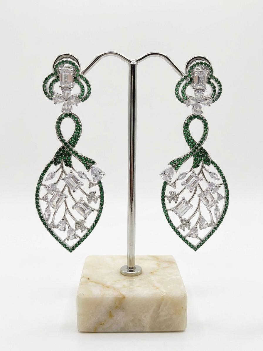 Detailed studio view of the Green American Diamond leaf-motif dangles, highlighting the 2cm width and shimmering stone-encrusted frame.