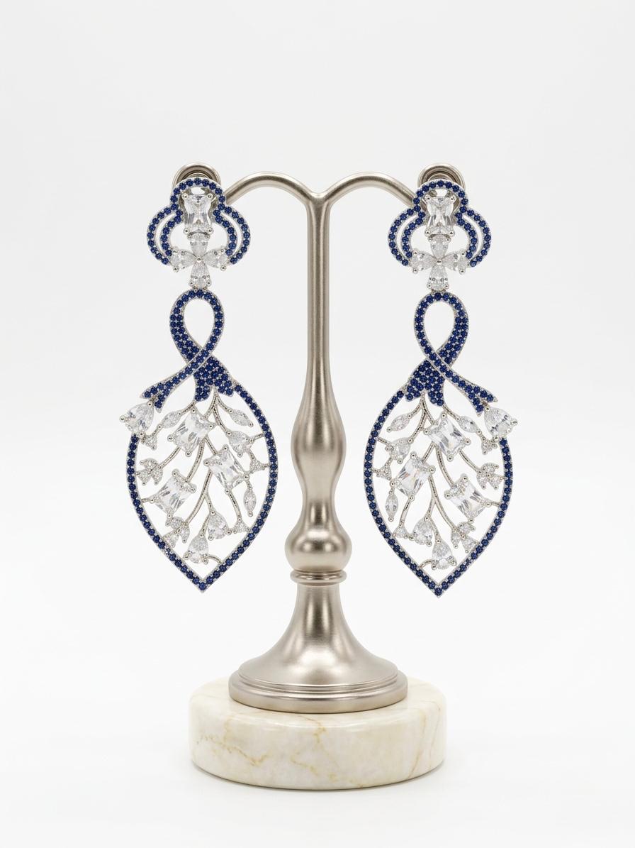 Detailed studio view of the Navy Blue American Diamond leaf-motif dangles, highlighting the 2cm width and shimmering stone-encrusted frame.