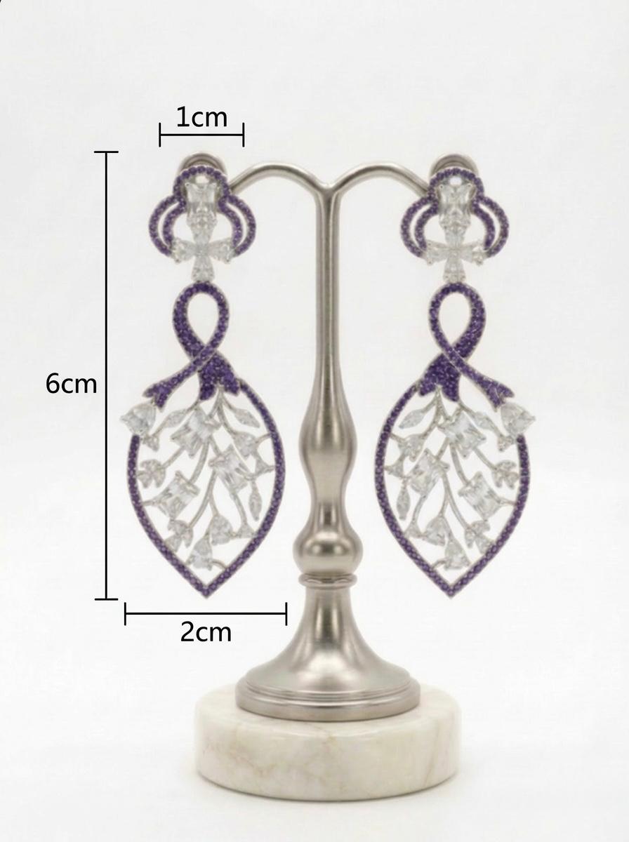 Detailed studio view of the Purple American Diamond leaf-motif dangles, highlighting the 2cm width and shimmering stone-encrusted frame.