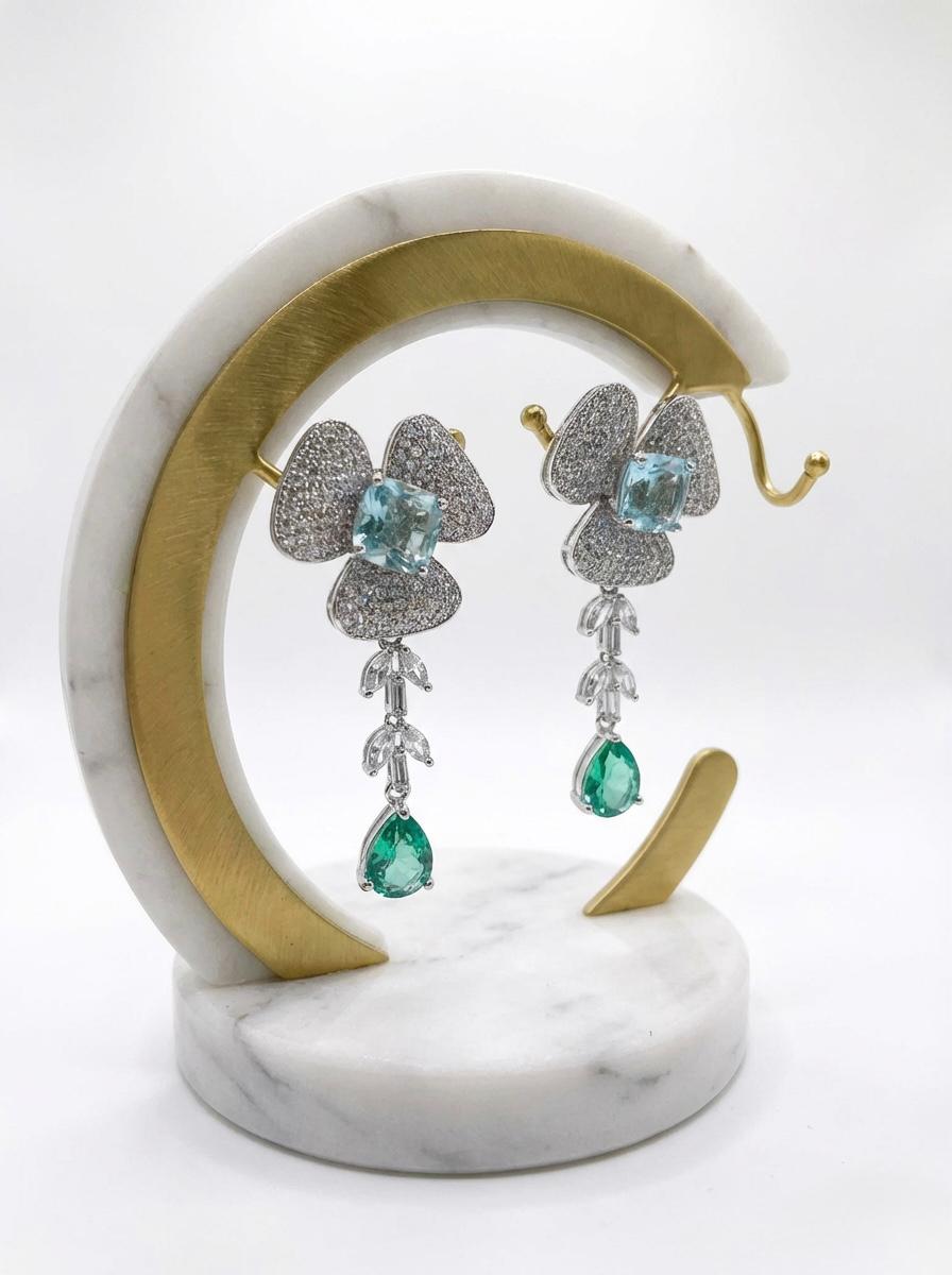  Detailed view of the petal-inspired green American Diamond jewelry, highlighting the shimmering pavé setting and teardrop crystal finish.