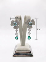 Detailed view of the petal-inspired green American Diamond jewelry, with measurments highlighting the shimmering pavé setting and teardrop crystal finish.